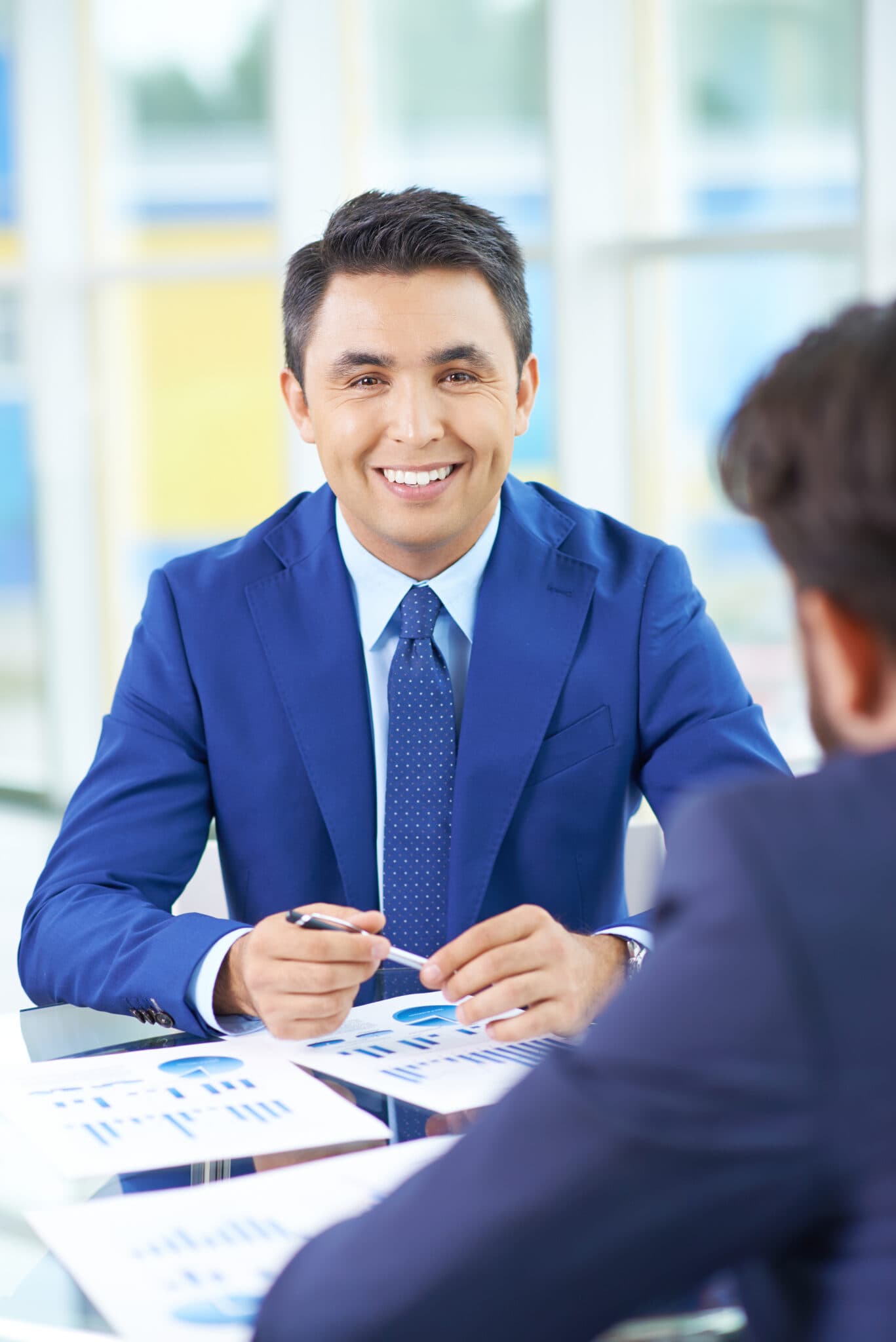 Business professionals discussing work at a desk